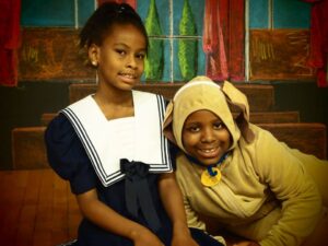 Students from the founding class performing in Annie Jr.